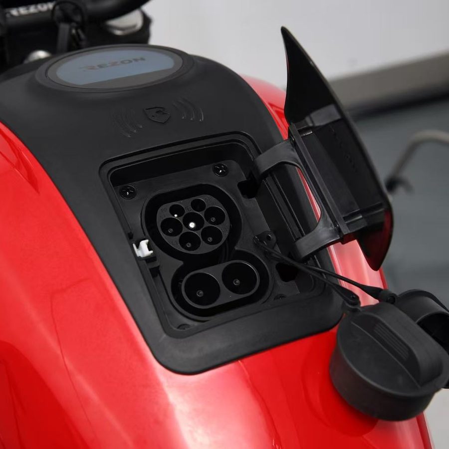 Combined Type 2 and CCS2 charging port under a flip cover on the tank