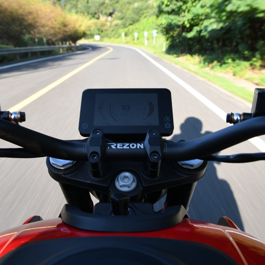 Rider's view of the Rezon handlebar and digital display on an open road